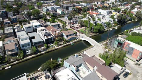 aerial view flying across sunny scenic california neighborhood houses and venice canals