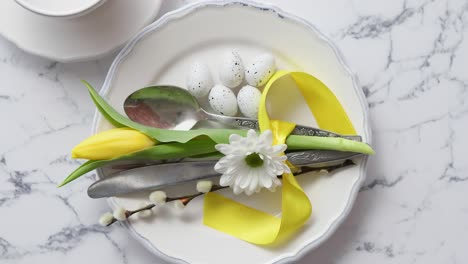 spring easter table setting at white marble table  top view