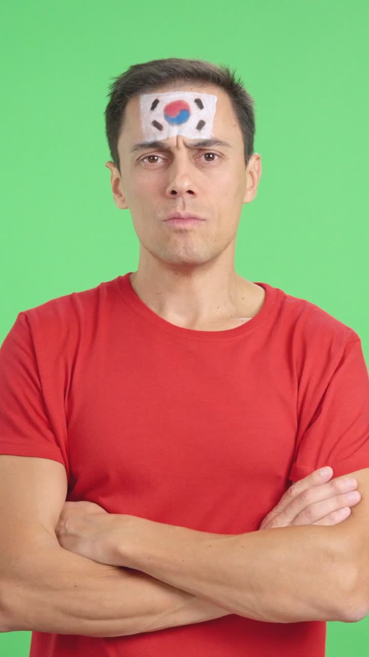 Dignified and serious man with south korean flag painted on face