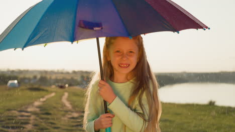 girl stands rotating umbrella under rain child under raindrops danced upon fabric creating