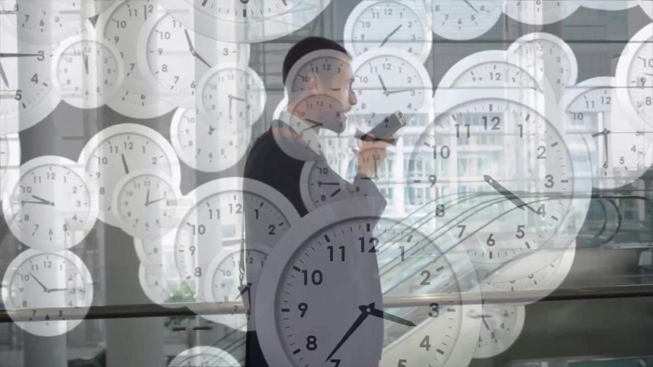 Animation of moving clocks over caucasian businessman talking on smartphone