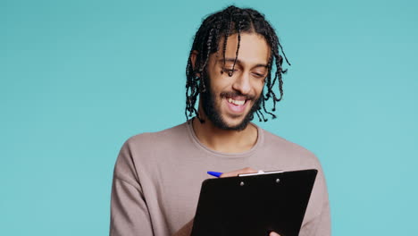 photographer holding clipboard in hand, completing shoot list, studio background