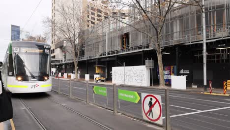 tram travels past construction site in melbourne