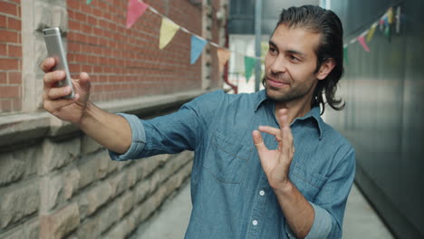 man taking selfie in urban alleyway