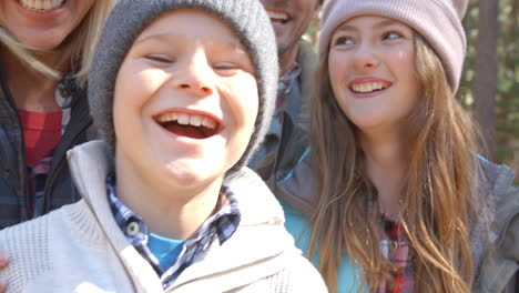 laughing family in forest, handheld close up shot