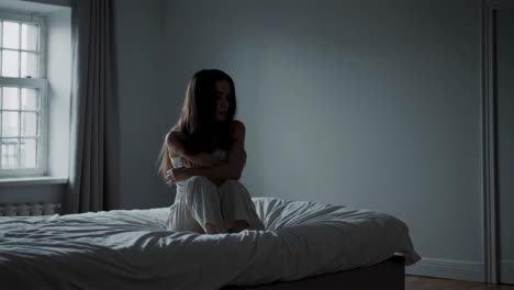 a woman alone in her bedroom