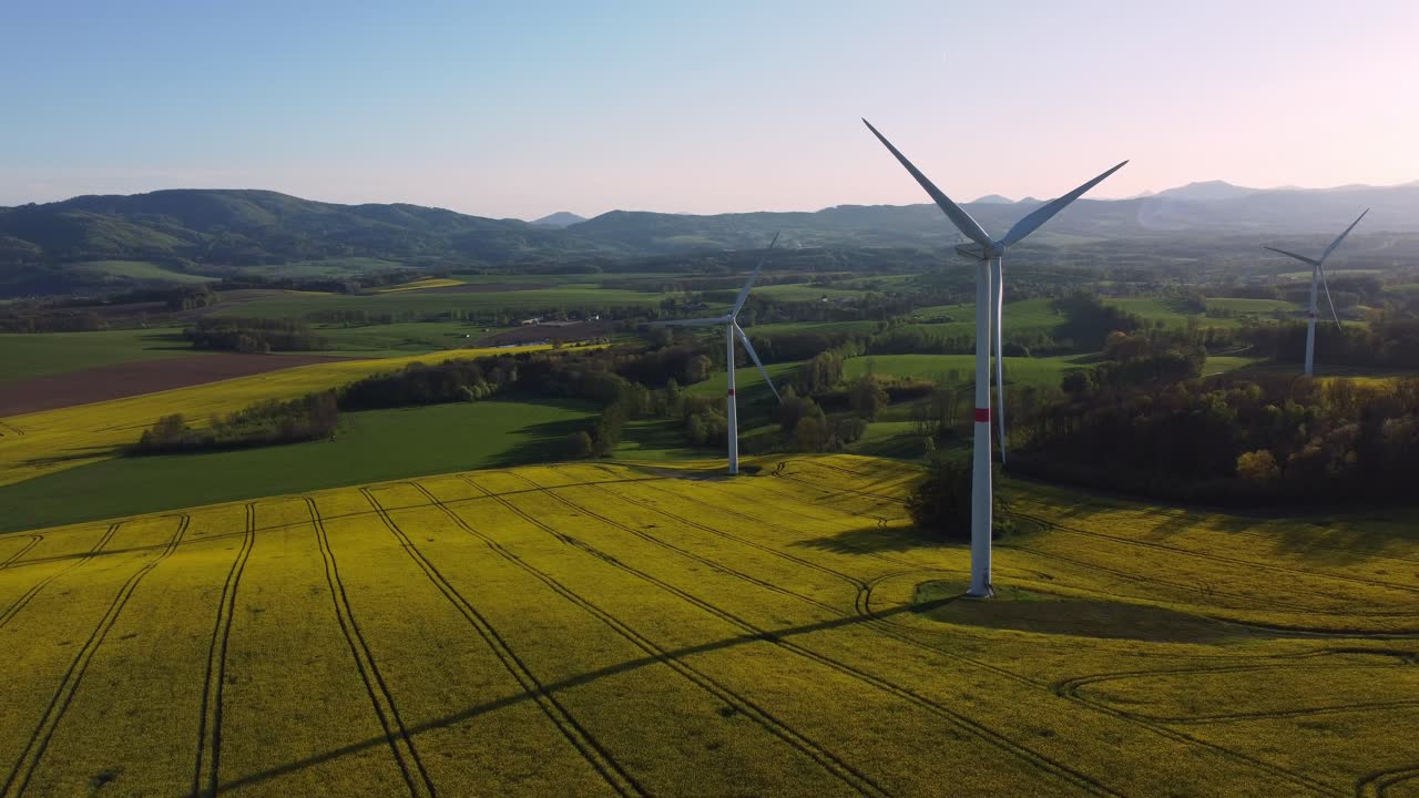 Drone fly around group of windmills, spring colors before sunset, copyspace