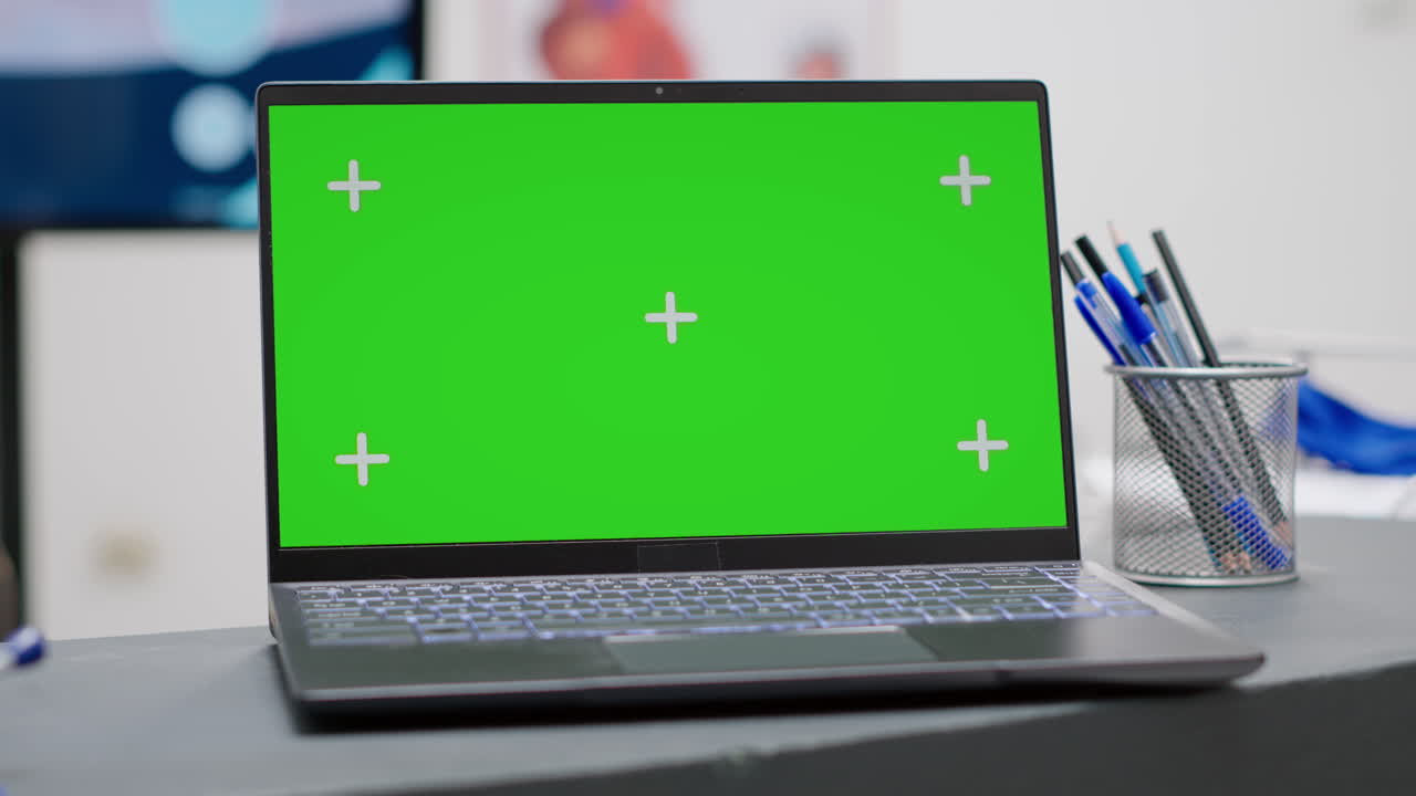 Laptop with Green Screen Mockup on Desk