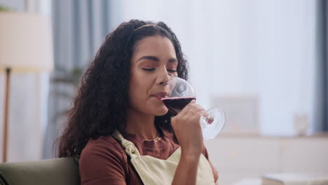 woman enjoying a glass of red wine at home