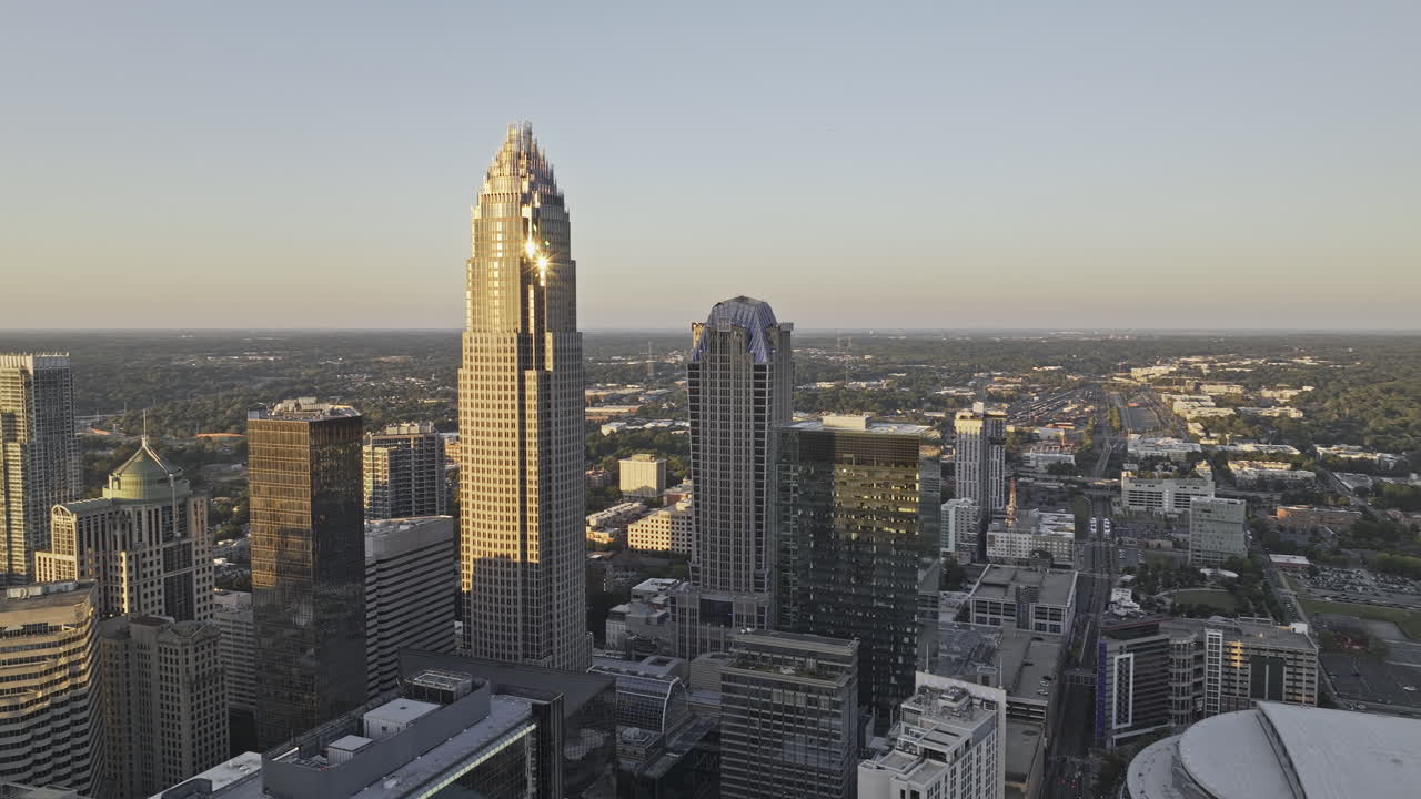 Charlotte North Carolina Aerial v147 flyover the city center capturing sunset downtown cityscape with golden lights casting a warm glow on building facades - Shot with Mavic 3 Pro Cine - Oct 1st 2023