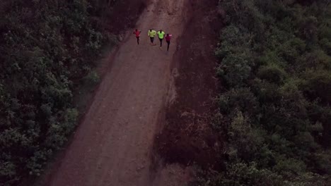 antena sobre corredores de kenia y atletas olímpicos entrenando en un camino de tierra en las colinas de ngong en nairobi, kenia