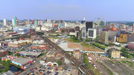 aerial drone establishing shot moving towards birmingham city centre and hs2 development site in england uk
