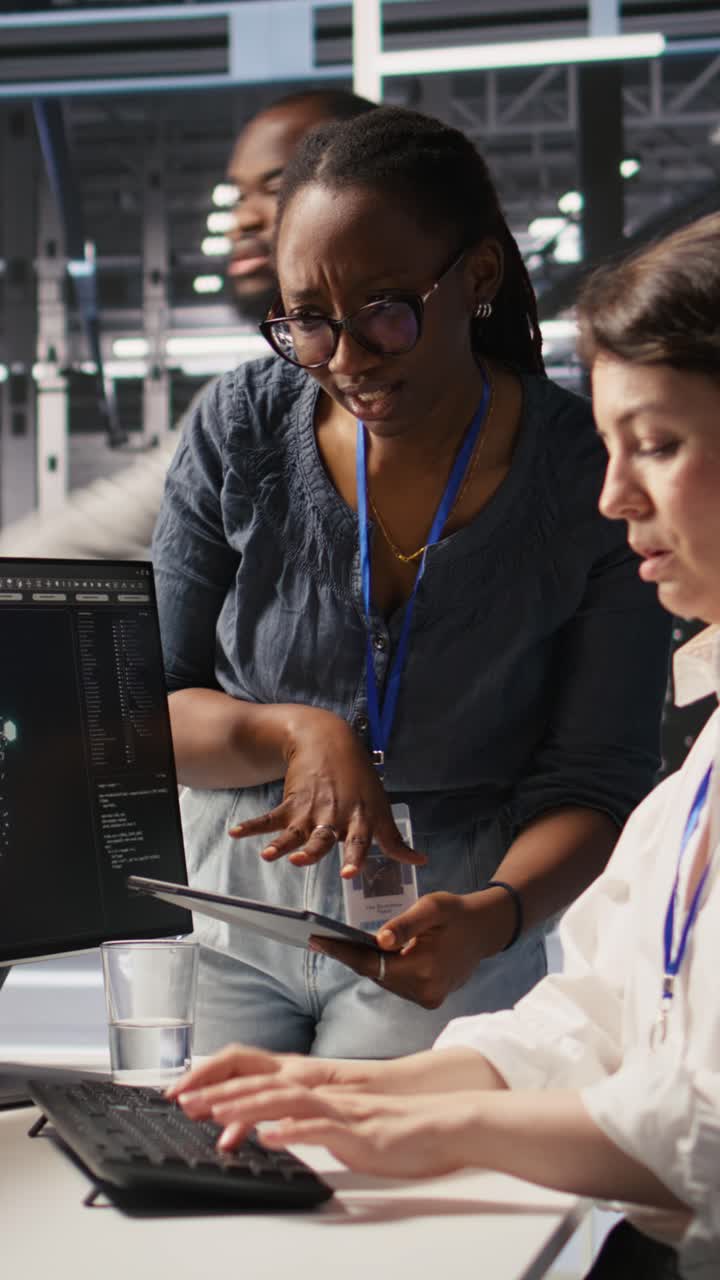 Vertical video Cheerful data center engineers doing fist bump after completing AI deployment