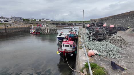 Ireland-epic-locations-sheltered-behind-the-seawall,-small-fishing-boats-at-low-tide-Slade-harbour-the-Hook-Wexford