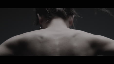 a woman dressed as mother nature moves slowly in a dance-like motion