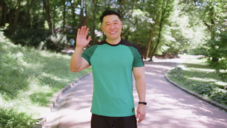 athletic runner sport man waving hi hello welcome with hand greeting with hospitable friendly smile