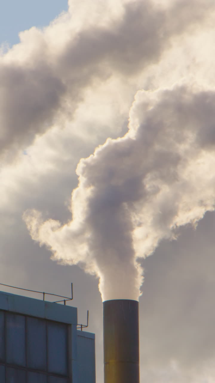 Harmful toxic greenhouse gases emitted by factory chimneys in Europe. Vertical
