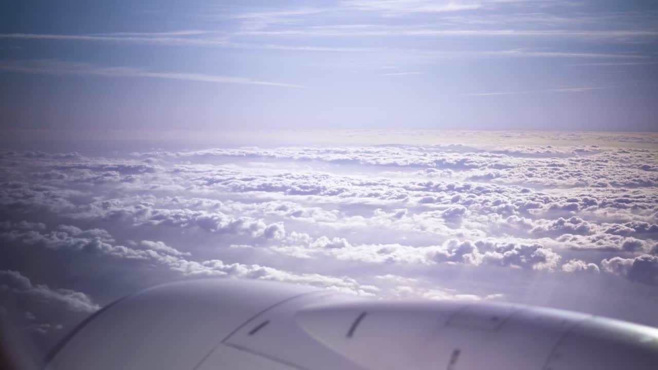 Plane flying above huge white clouds window view