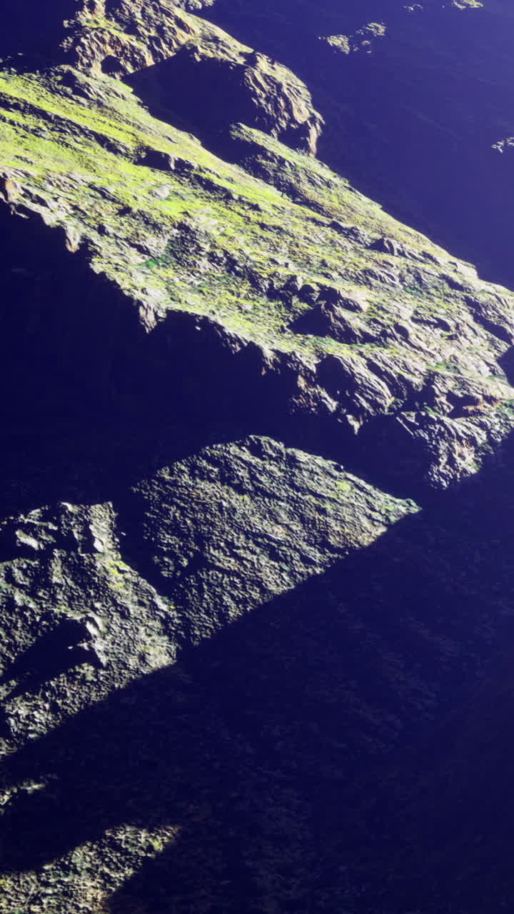 Nature scene showing rocky terrain with lush greenery in daylight hours