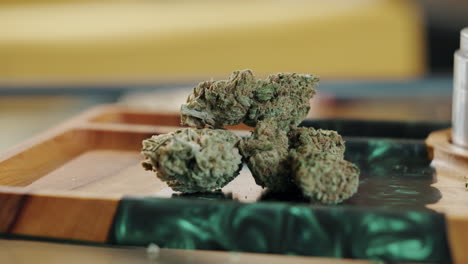 cannabis buds on a wooden tray