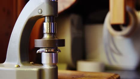 Horologist repairing a watch on a machine