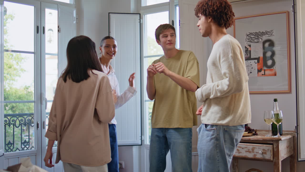 Dancing youngsters having fun at home party. Happy friends enjoy discotheque
