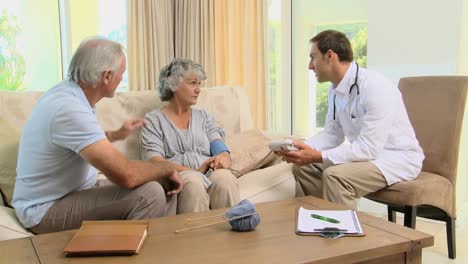 doctor measuring blood pressure at a patient