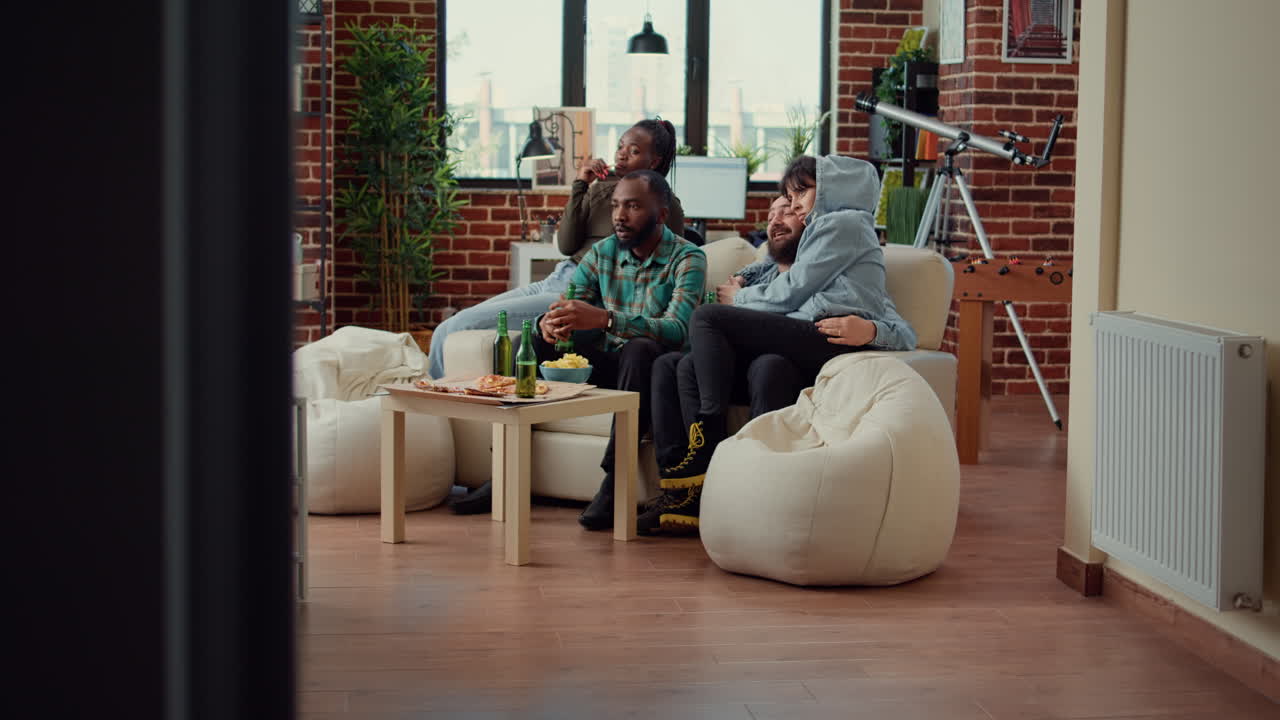 Frightened people watching scary horror movie on television