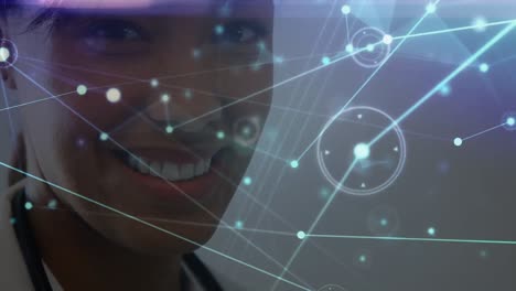 Network-of-connections-over-portrait-of-african-american-female-doctor-smiling-at-hospital