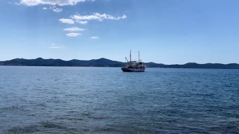 time-lapse of a ship moored in the adriatic sea on a sunny day near zadar croatia with waves passing.