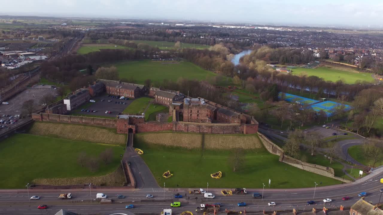 Drone retreating to reveal Carlisle Castle, Castle Way Road and River Eden in the background - Cumrbia England