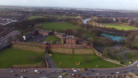 drone retreating to reveal carlisle castle, castle way road and river eden in the background - cumrbia england