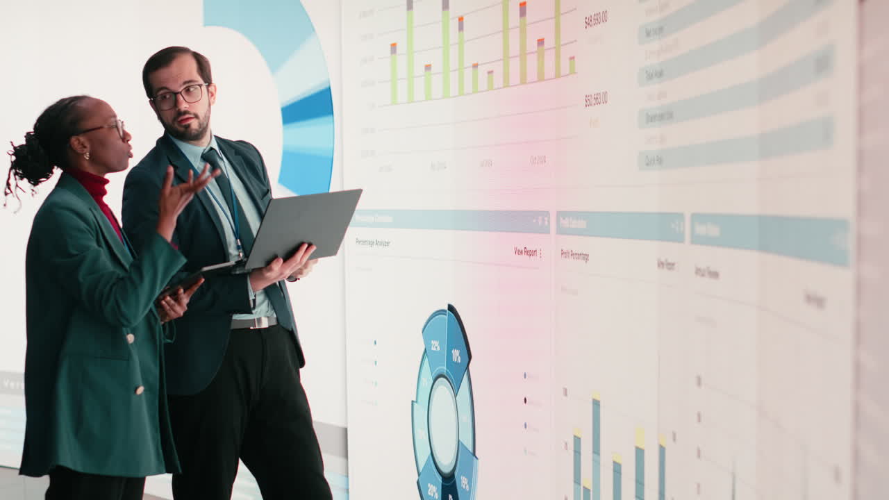 Business Professionals Discussing Data on Large Interactive Screen