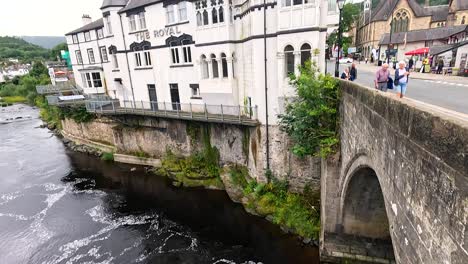 people walking on bridge over river