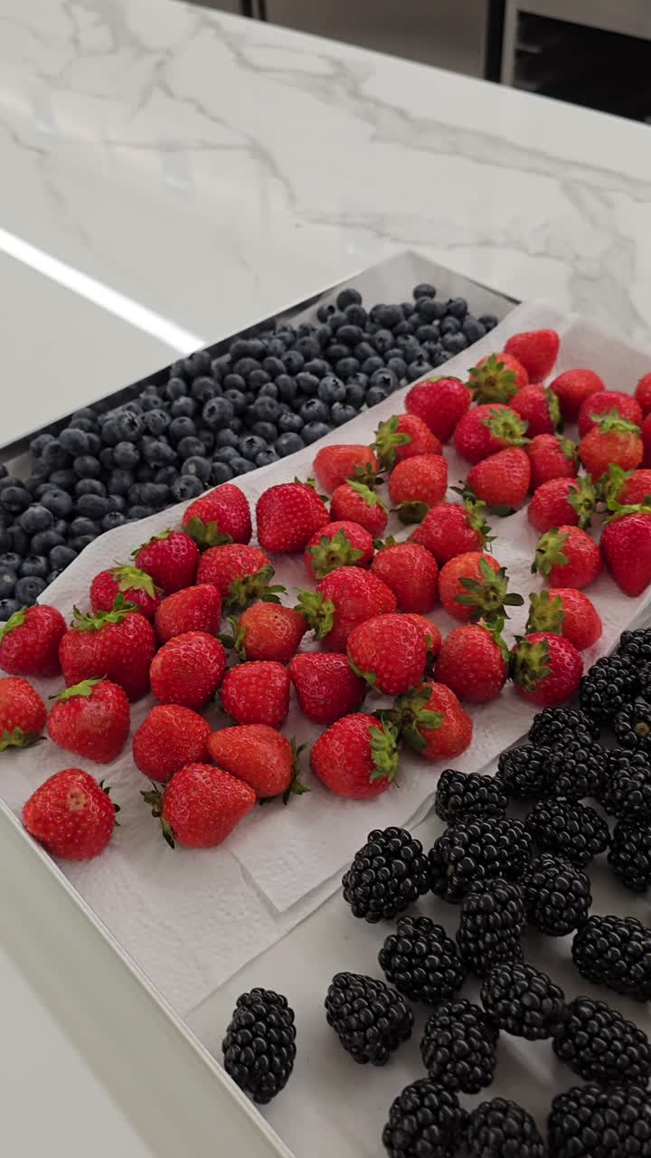A variety of fresh berries arranged for cake and muffin decorations at a bakery shop