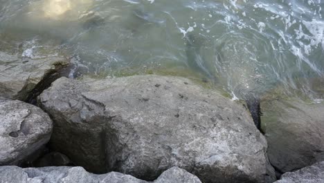 slow motion of water waves hitting rocks at shore