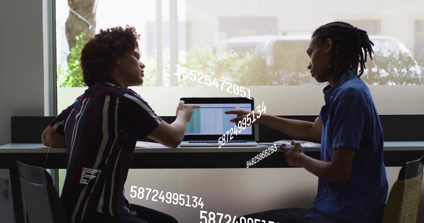 Discussing data with floating numbers, two people using laptop in school setting