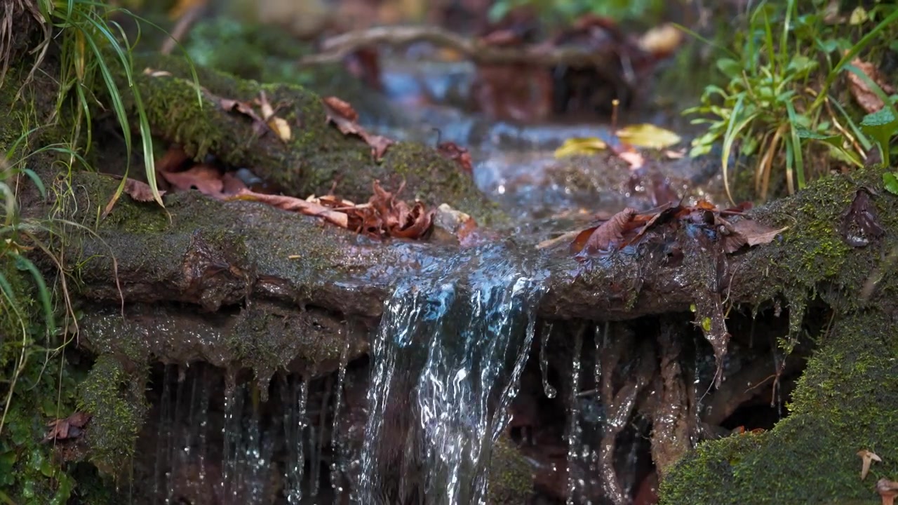 Water stream falling from pile of rocks