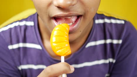 boy eating lollipop close up ,