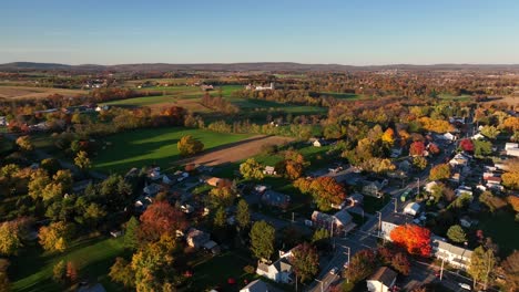 rural farm fields in usa surrounded by neighborhood village housing