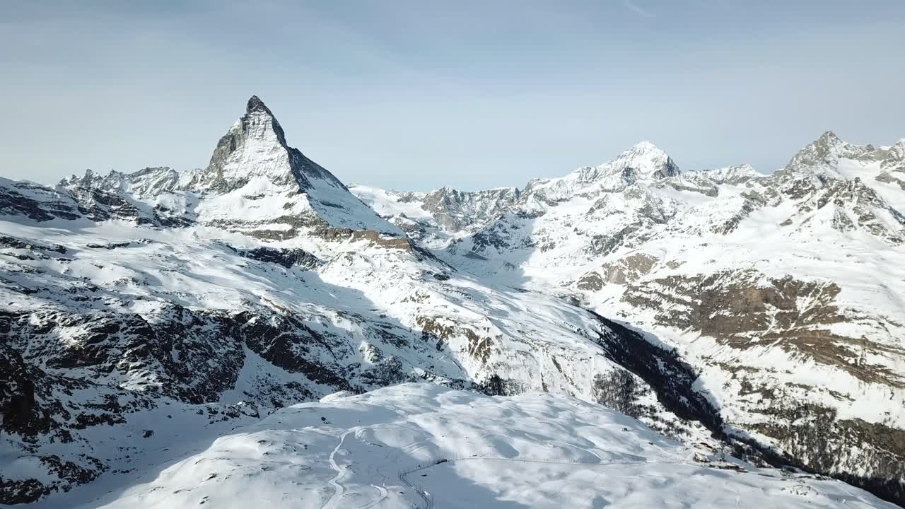 Snow covered slopes and jagged peaks create a breathtaking vista in the swiss alps, the standing Matterhorn near-symmetric peak in the extended Monte Rosa area of the Pennine Alps, Switzerland