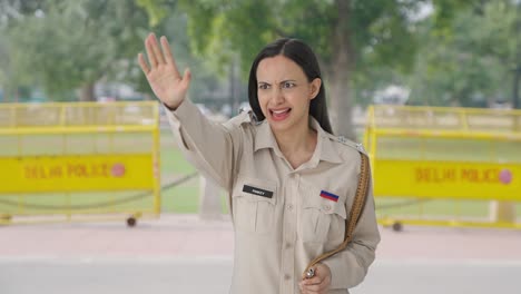 Angry-Indian-female-police-officer-stopping-someone-using-whistle