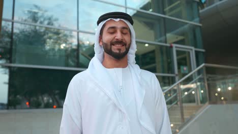 portrait of happy arab man with modern business background