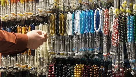 mid shot of man looking at beads