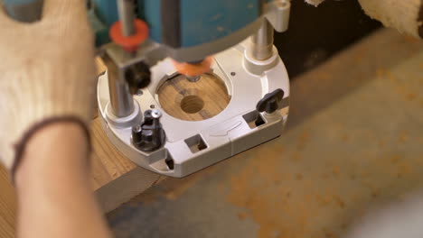 close-up of a person using a wood router