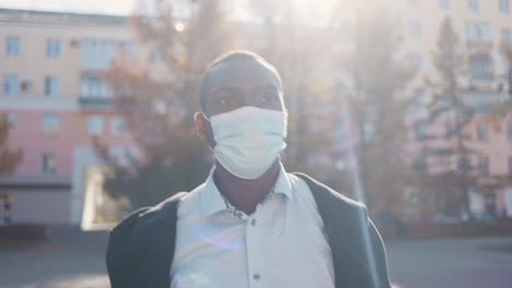 man wearing a mask outdoors in the city