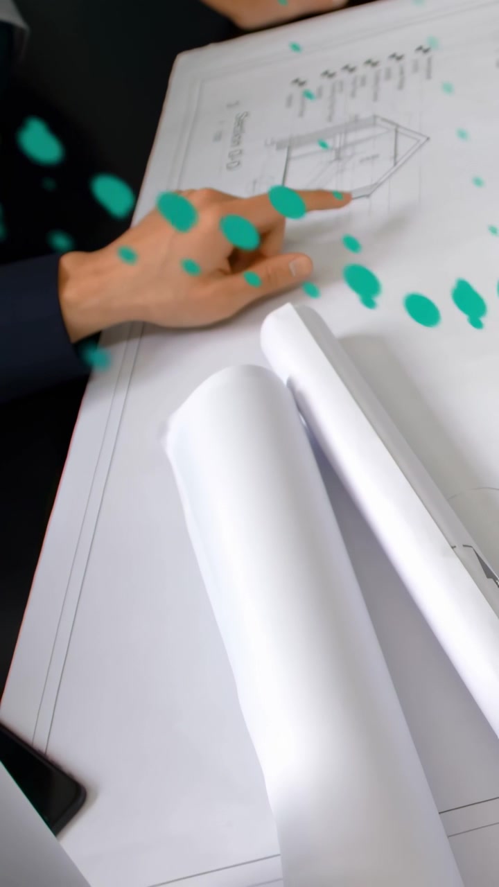 Vertical video: Architect's hand tapping and tracing plan, sparking teal overlays, reviewing layout