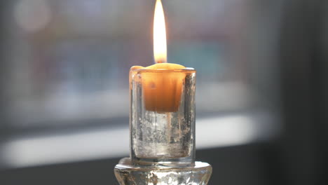 Person-Lighting-A-Candle-Using-A-Torch-Lighter