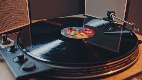 Close-up video of a spinning vinyl record on a turntable, shot from a low angle, capturing the retro