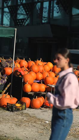 woman at a fall pumpkin market